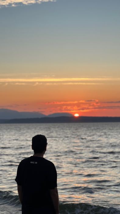 Silhouette watching the sun set over Puget Sound